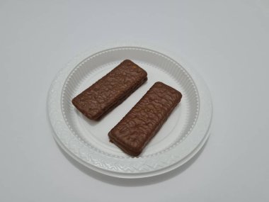 Snacks made from flour and other ingredients, namely chocolate-flavored biscuits