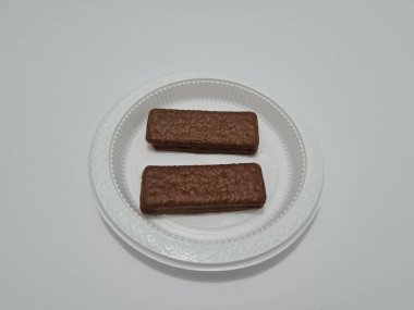 Snacks made from flour and other ingredients, namely chocolate-flavored biscuits
