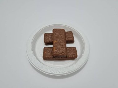 Snacks made from flour and other ingredients, namely chocolate-flavored biscuits