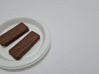 Snacks made from flour and other ingredients, namely chocolate-flavored biscuits