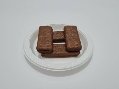 Snacks made from flour and other ingredients, namely chocolate-flavored biscuits