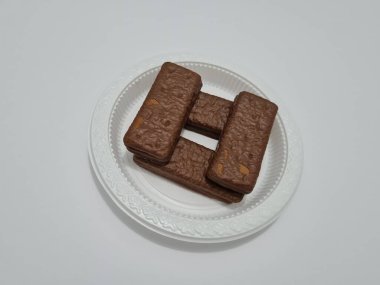 Snacks made from flour and other ingredients, namely chocolate-flavored biscuits