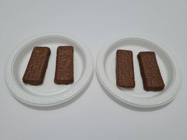 Snacks made from flour and other ingredients, namely chocolate-flavored biscuits