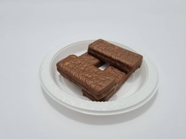 Snacks made from flour and other ingredients, namely chocolate-flavored biscuits