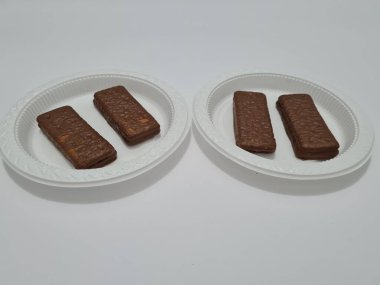 Snacks made from flour and other ingredients, namely chocolate-flavored biscuits