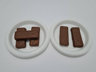Snacks made from flour and other ingredients, namely chocolate-flavored biscuits
