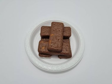 Snacks made from flour and other ingredients, namely chocolate-flavored biscuits
