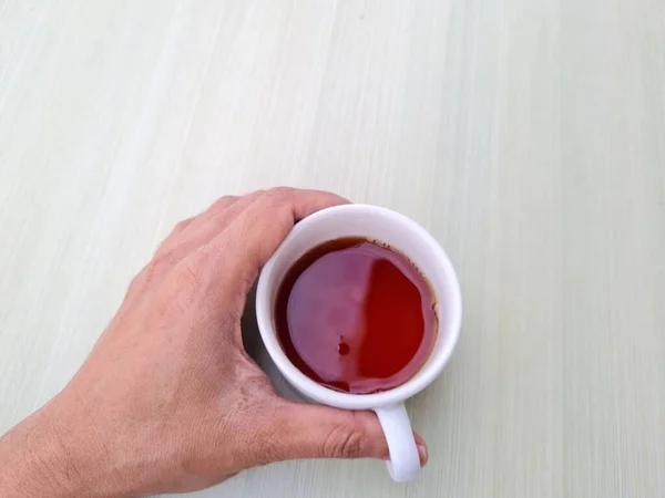 Teenage Boy Hand Holding White Mug Filled Tea White Background — Stock Photo, Image
