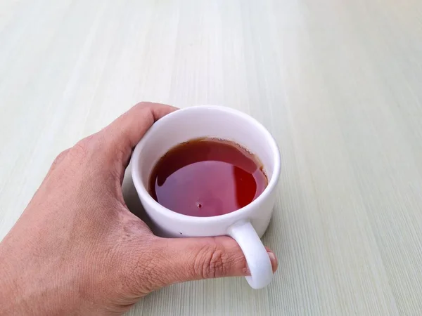 Teenage Boy Hand Holding White Mug Filled Tea White Background — Zdjęcie stockowe