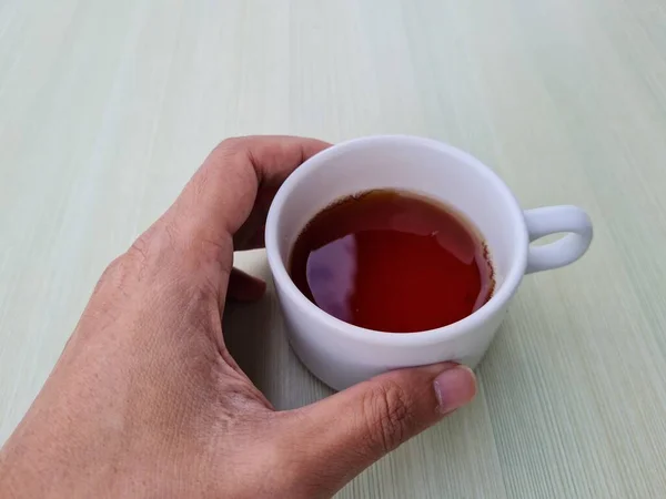 Teenage Boy Hand Holding White Mug Filled Tea White Background — Stock fotografie