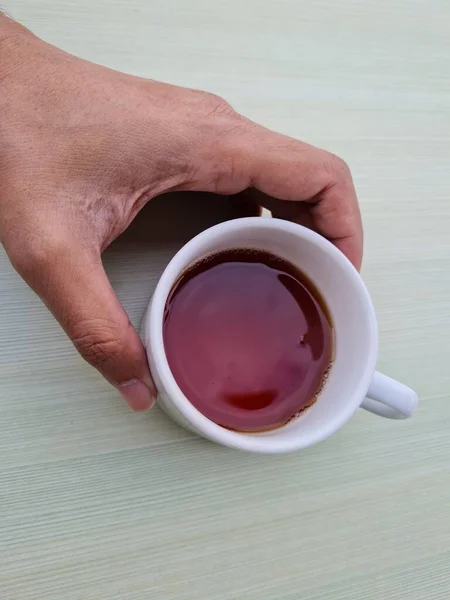 Teenage Boy Hand Holding White Mug Filled Tea White Background — ストック写真