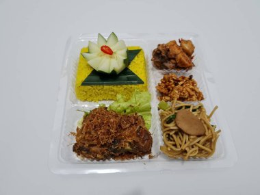 Yellow rice with fried chicken, fried noodles, fried chili and others