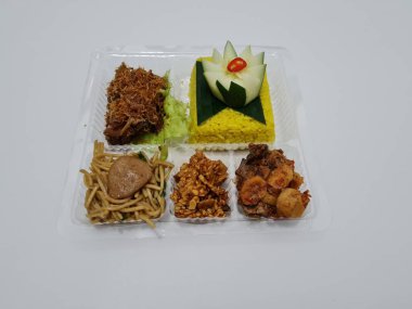 Yellow rice with fried chicken, fried noodles, fried chili and others