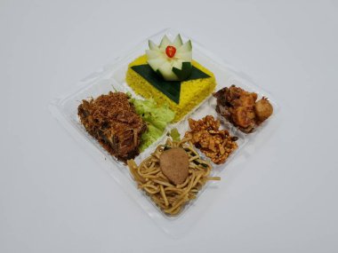 Yellow rice with fried chicken, fried noodles, fried chili and others