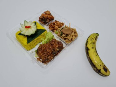 Yellow rice with fried chicken, fried noodles, fried chili and others