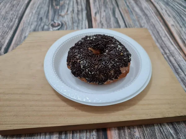 Cake made from flour and other ingredients, namely donut cake sprinkled with chocolate messes