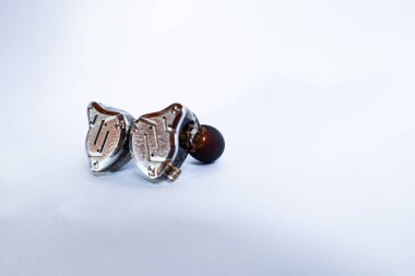 Pair of in-ear monitors without cable on an isolated white background