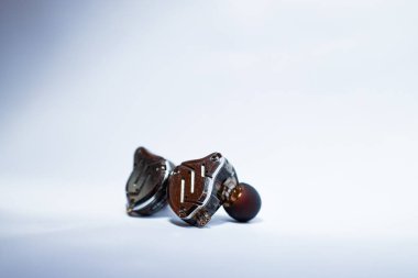 Pair of in-ear monitors without cable on an isolated white background