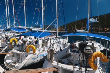 Agia Efimia, Cephalonia Adası, Yunanistan - 14 Temmuz 2019: Agia Efimia limanındaki bir rıhtımda mavi gökyüzüne karşı kiralanmak üzere beyaz yatları kapatın