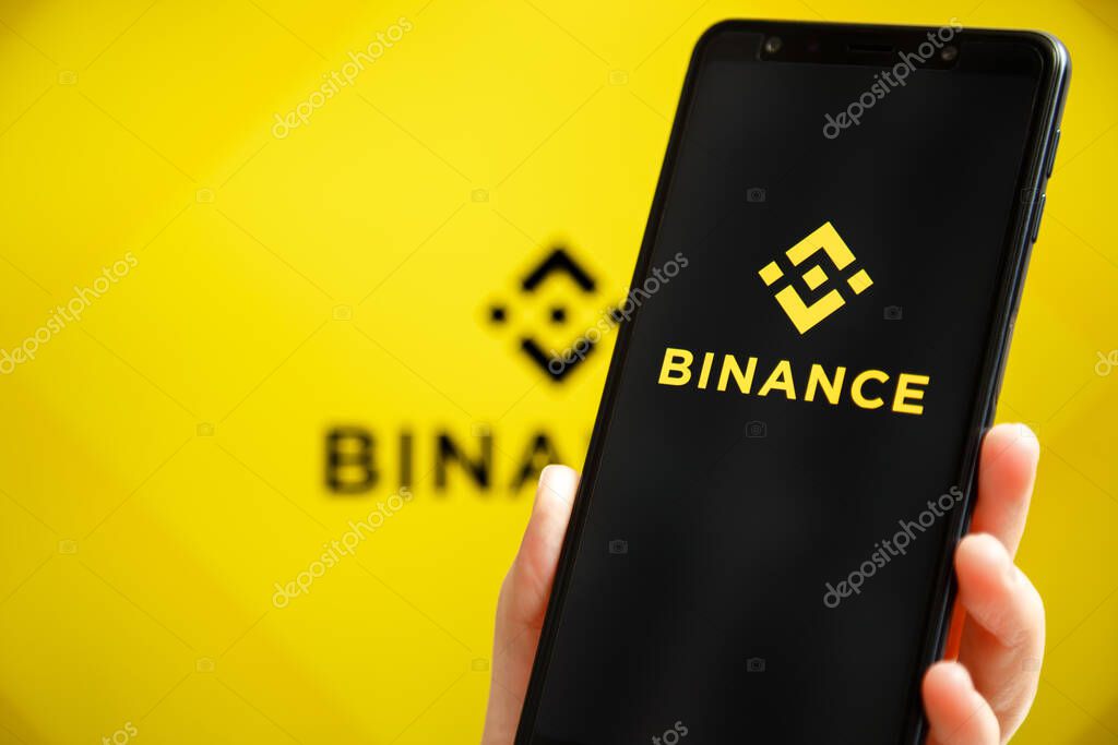 Ukraine, Odessa - October, 9 2021: Binance mobile app running at smartphone screen with Binance logo at background. Binance one of the world's leading cryptocurrency exchange and trading platform