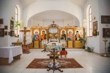 ODESSA, UKRAINE - MAY 1, 2015: Ukrainian Orthodox Christian Church. Preparing for christening in the church, church interior view, golden religious utensils: bible, cross, baptismal font.