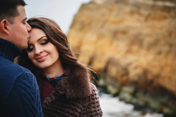 Close up of romantic attractive young couple hugging at the coast.