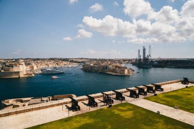 VALLETTA, MALTA - SEPTEMBER, 15 2018: Guns, cannons at Saluting Battery in Upper Barrakka Gardens in Valletta, Malta with commanding view of Grand Harbor. For almost 500 years it protected harbor.