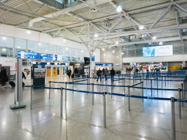 Athens, Greece - February, 11 2020: Athens International Airport Eleftherios Venizelos. Passengers in the departure hall of the main terminal looking for their check in desk.