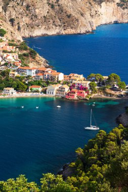 Close up top view at Asos village, Assos peninsula and fantastic blue Ionian Sea water. Aerial view, summer scenery of famous and extremely popular travel destination in Cephalonia, Greece, Europe