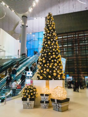 Istanbul, Turkey - February, 11 2020: Passengers in the departure hall of IGA Istanbul Airport on the escalator, going to the gates. Christmas decoration inside the Istanbul Airport.