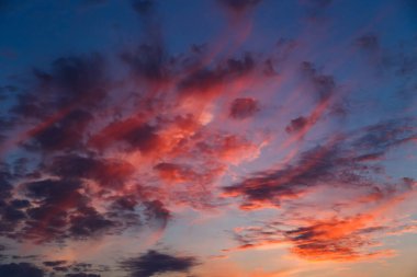 A stunning pink, orange and blue clouds at sunset sky, sunset background