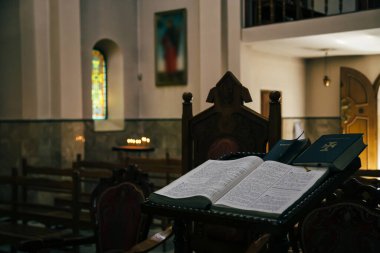 ODESSA, UKRAINE - JULY 5, 2014: The open Bible in armenian language lying in the empty dark Armenian Church.