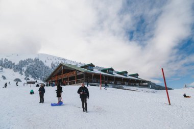 Kalavryta ski Resort, Greece - December, 31 2019: Kalavrita ski center chalet at snowy slope with splendid snow-covered mountains view in background. Winter vacation