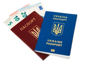 New ukrainian blue international biometric passport with identification chip lying on old ukrainian red international passport with euro banknotes cash inside, isolated on white
