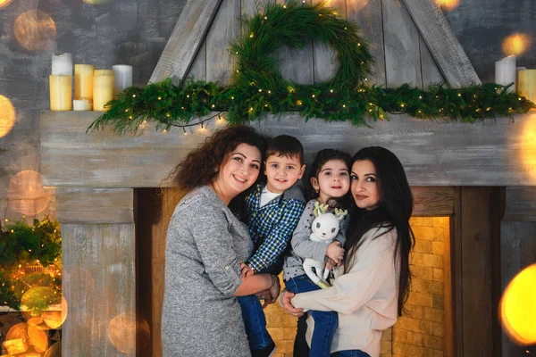 Christmas Family Portrait Happy Smiling Mothers Hugging Children Fireplace Decorated — Stockfoto