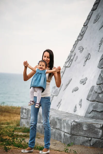 Happy Young Mother Playing Small Daughter Throwing Air Outdoors Background — Stockfoto