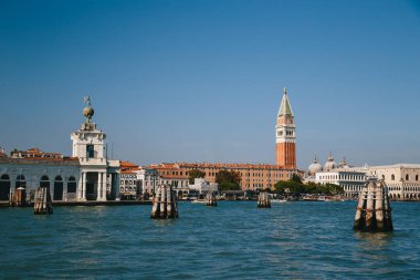 Venice, Italy - September, 9 2018: St. Mark's Square, Doges Palace, St Mark's Campanile bell tower, Punta della Dogana and other sights of the centre of Venice from the boat.