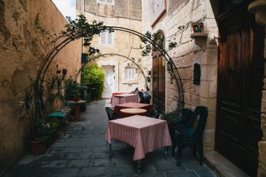 MDINA, MALTA - SEPTEMBER, 15 2018: Beautiful view of narrow medieval street in Mdina, ancient capital of Malta, fortified medieval town. Popular touristic destination and attraction.