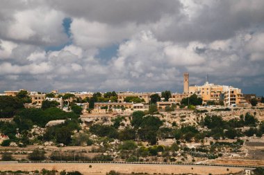 Beautiful panoramic view of Malta island and Mtarfa Clock Tower from the top of Bastion Square at Mdina, ancient capital of Malta, fortified medieval town.