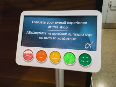 Athens, Greece - February, 11 2020: Customer service evaluation and satisfaction survey in Athens International Airport. Colorful service reaction and feedback assessment monitor for passengers.