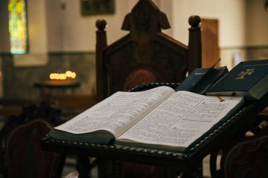 ODESSA, UKRAINE - JULY 5, 2014: The open Bible in armenian language lying in the empty dark Armenian Church.