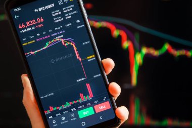 Ukraine, Odessa - September, 7 2021: Bitcoin dump. Trading pair BTC USDT at Binance mobile app running at mobile screen with trading page at background. Cryptocurrency exchange and trading platform