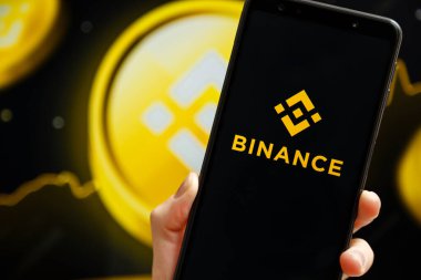 Ukrayna, Odessa - 9 Ekim 2021: Binance uygulaması arka planda Binance logosu ile akıllı telefon ekranında çalışan el bilgisayarı. Binance kripto döviz ve ticaret platformudur.