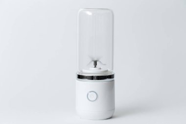 Portable mini blender for making smoothie isolated on white background.