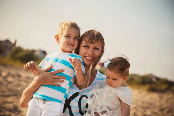 Close Young Smiling Mother Hugging Her Small Kids Having Fun — Stok fotoğraf