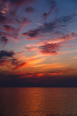 A stunning pink and orange sunset sky in the middle of Mediterranean sea, sunset background