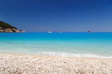 A fantastic view at empty Myrtos Beach with turquoise and blue Ionian Sea water. Summer scenery of famous and extremely popular travel destination in Cephalonia, Greece, Europe