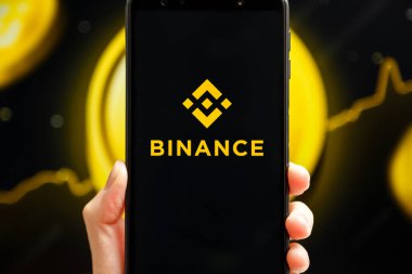 Ukrayna, Odessa - 9 Ekim 2021: Binance uygulaması arka planda Binance logosu ile akıllı telefon ekranında çalışan el bilgisayarı. Binance kripto döviz ve ticaret platformudur.