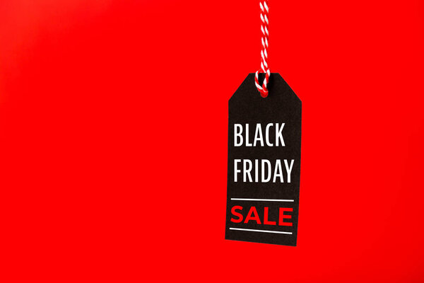Black Friday Sale black price tag isolated on red background. Shopping, sale, discount concept