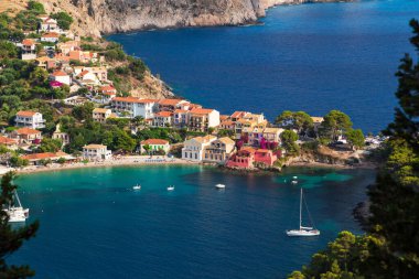 Close up top view at Asos village, Assos peninsula and fantastic blue Ionian Sea water. Aerial view, summer scenery of famous and extremely popular travel destination in Cephalonia, Greece, Europe